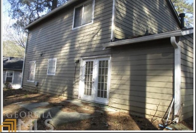 view of side of property featuring french doors