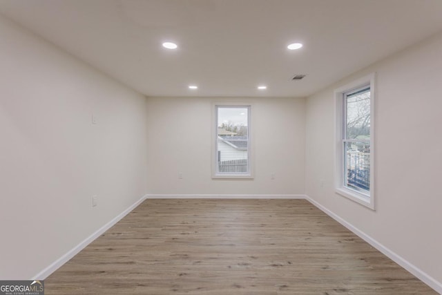 spare room featuring light hardwood / wood-style flooring