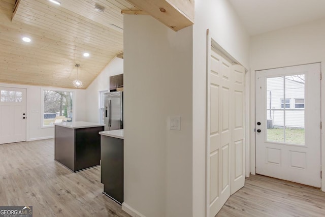 entrance foyer with plenty of natural light, wood ceiling, lofted ceiling, and light hardwood / wood-style flooring