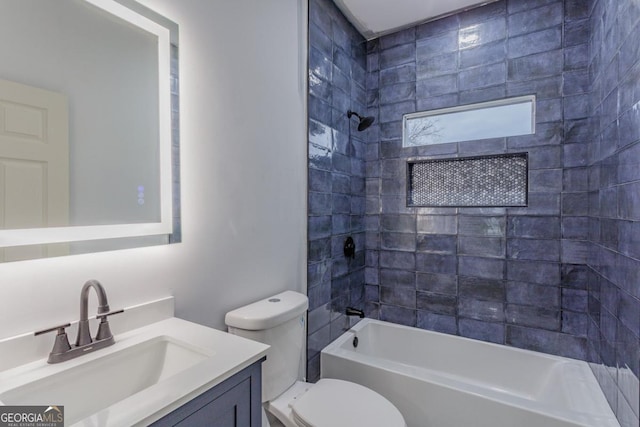 full bathroom with tiled shower / bath combo, toilet, and vanity