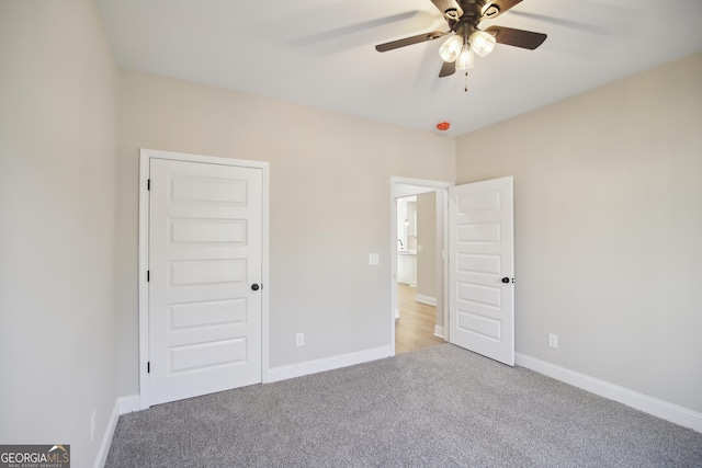 unfurnished bedroom featuring ceiling fan and light carpet