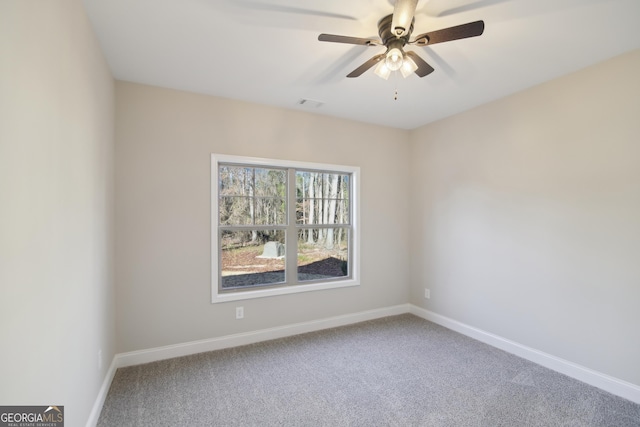 spare room featuring carpet and ceiling fan