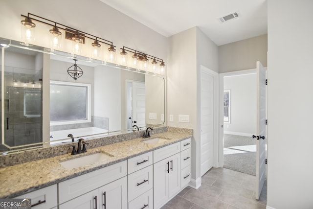 bathroom with tile patterned floors, vanity, and a bathing tub