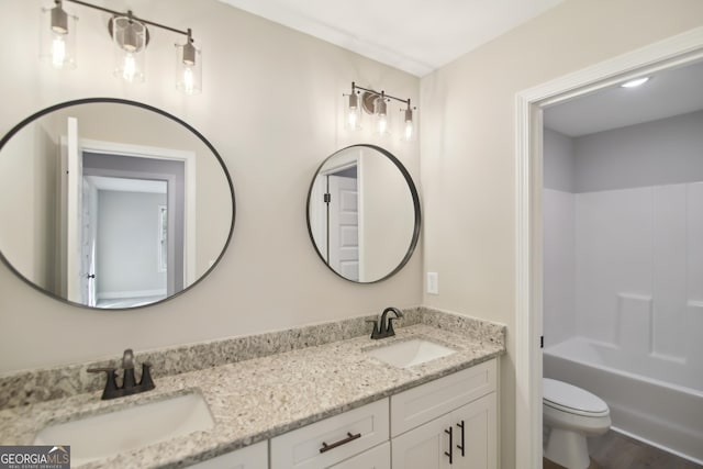 full bathroom featuring wood-type flooring, vanity, tub / shower combination, and toilet