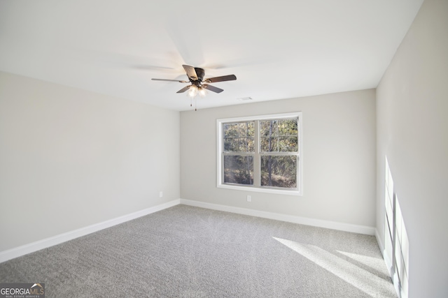 unfurnished room with ceiling fan and carpet floors