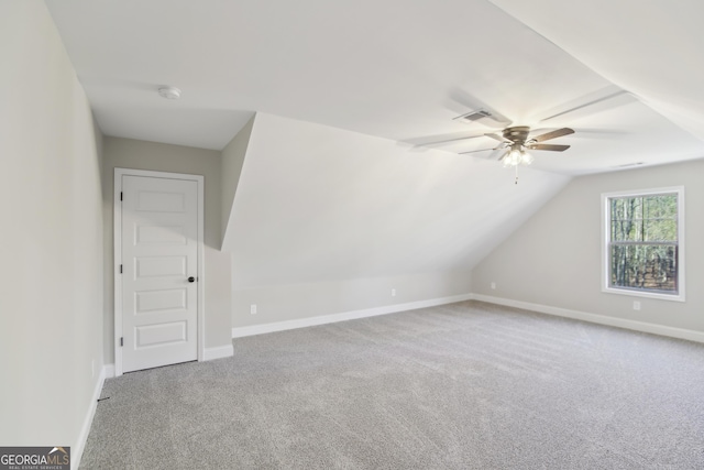 additional living space with carpet flooring, ceiling fan, and vaulted ceiling