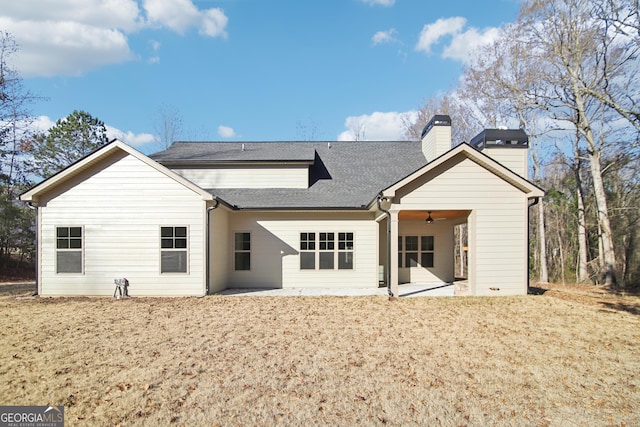 rear view of property with ceiling fan and a patio