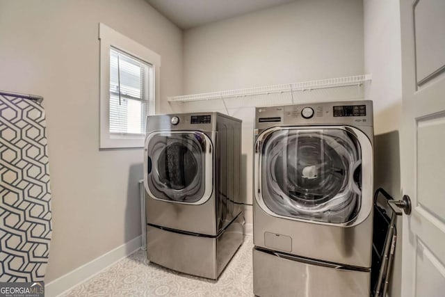 washroom featuring washing machine and clothes dryer