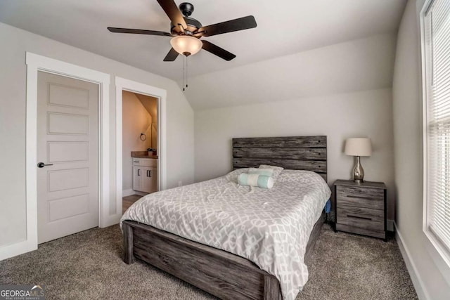 bedroom with connected bathroom, ceiling fan, carpet floors, and lofted ceiling