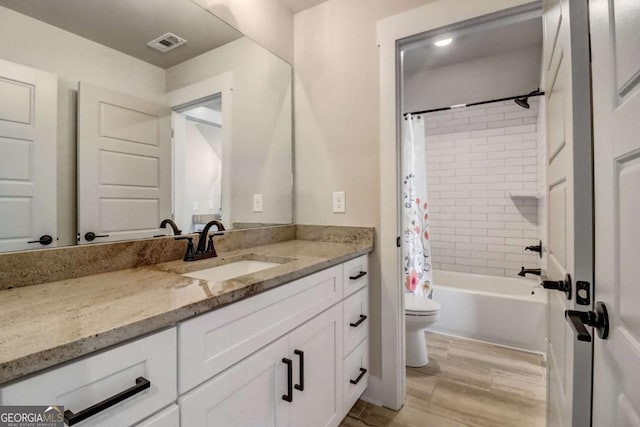 full bathroom with hardwood / wood-style floors, vanity, shower / bath combination with curtain, and toilet