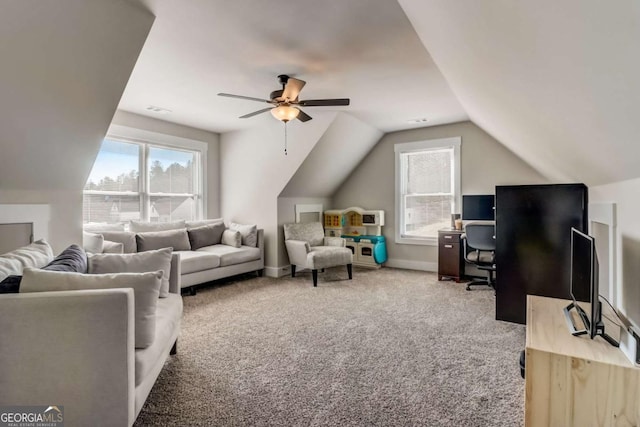 carpeted living room with ceiling fan and lofted ceiling