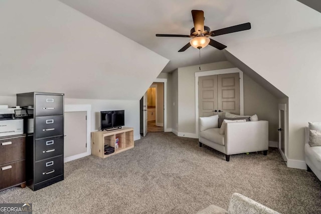 sitting room with ceiling fan, light carpet, and vaulted ceiling