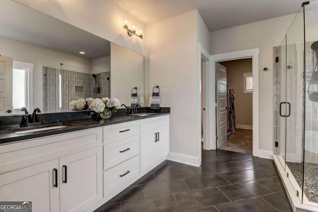 bathroom with tile patterned floors, vanity, and a shower with shower door