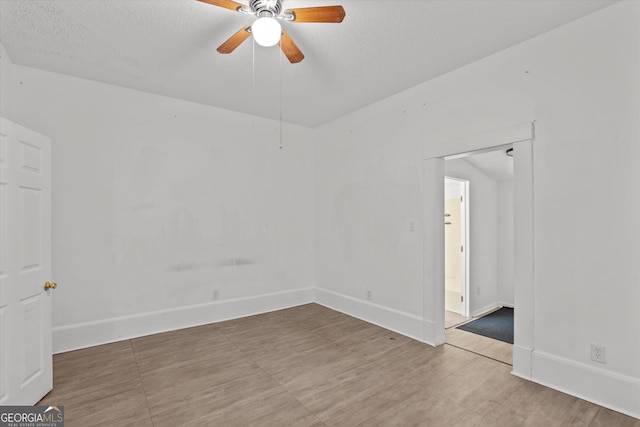 spare room with ceiling fan and a textured ceiling