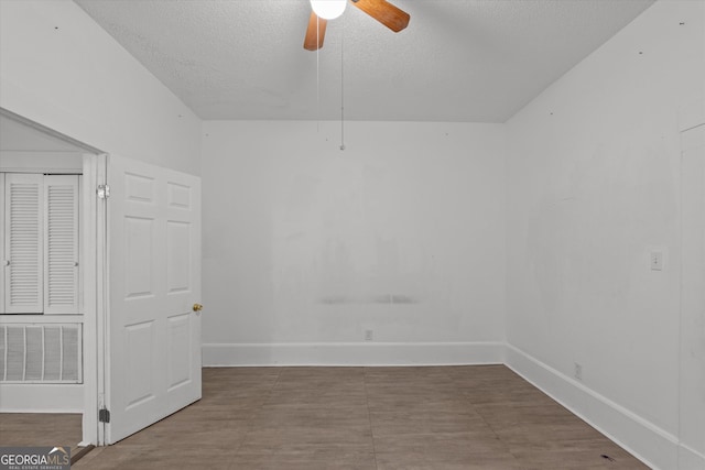 spare room with ceiling fan and a textured ceiling