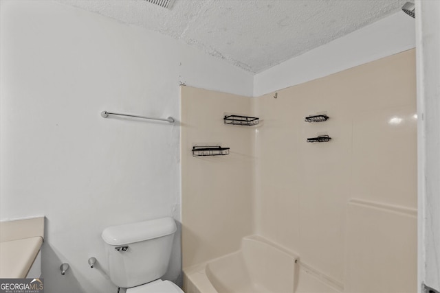 bathroom featuring toilet and a textured ceiling