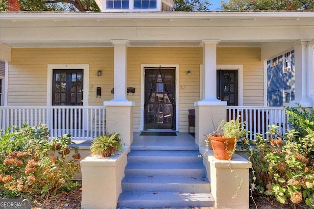 entrance to property featuring a porch