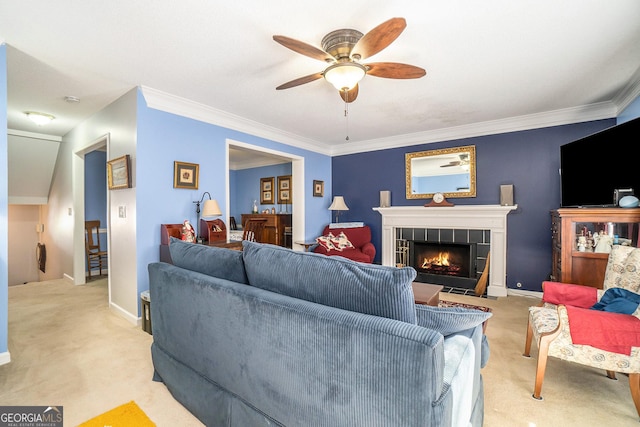 carpeted living room with a fireplace, ceiling fan, and ornamental molding