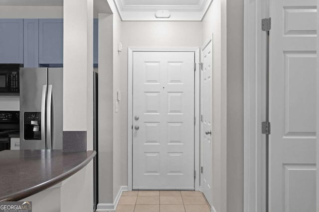 doorway to outside with light tile patterned flooring and crown molding