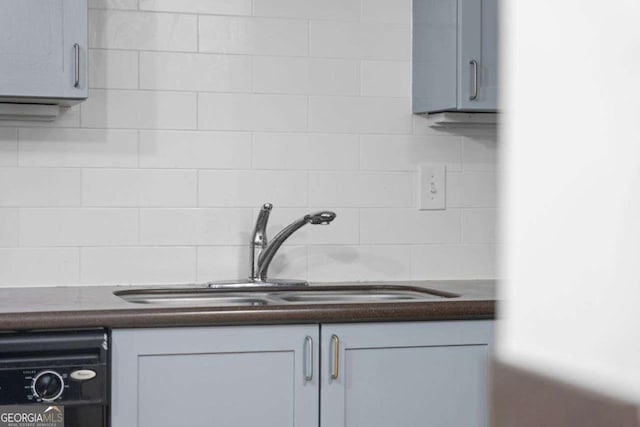 details with tasteful backsplash, gray cabinetry, sink, and black dishwasher