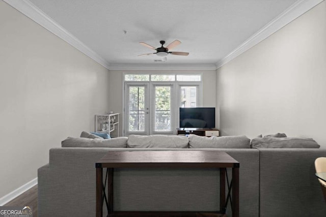 living room with crown molding, dark hardwood / wood-style flooring, ceiling fan, and french doors