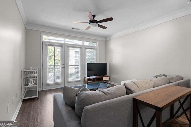 living room with dark hardwood / wood-style floors, ceiling fan, and ornamental molding