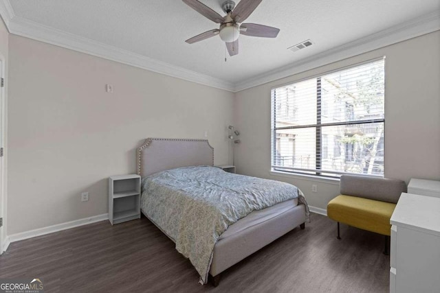 bedroom with dark hardwood / wood-style flooring, ceiling fan, and crown molding