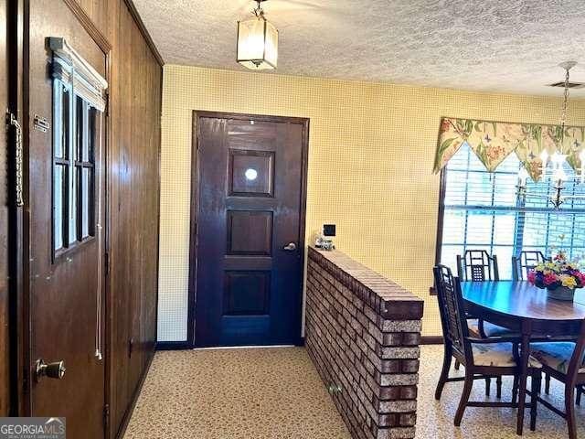 entrance foyer featuring a chandelier and a textured ceiling