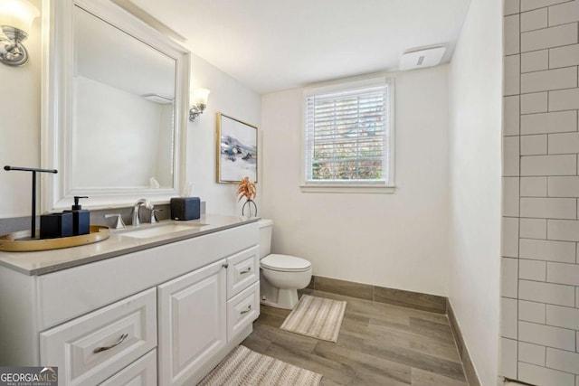 bathroom featuring vanity and toilet