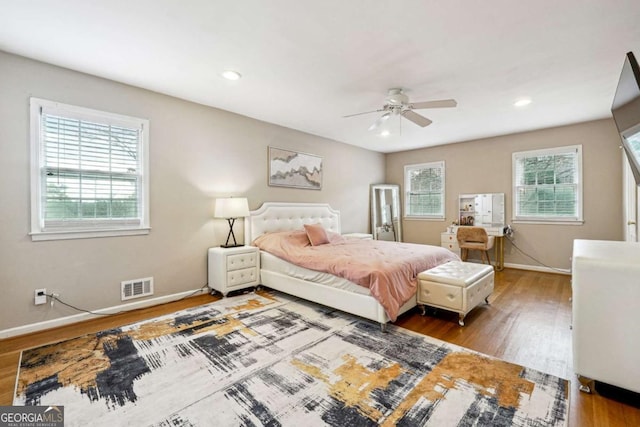 bedroom with ceiling fan and dark hardwood / wood-style flooring