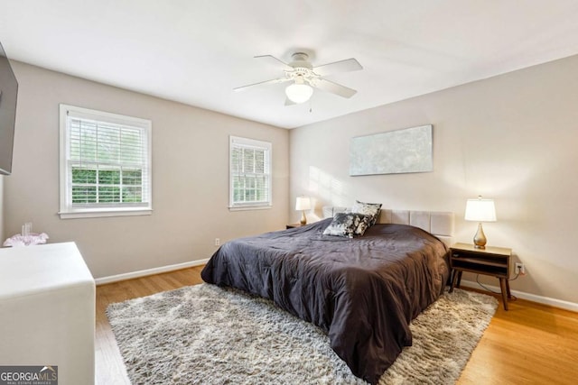 bedroom featuring light hardwood / wood-style flooring and ceiling fan