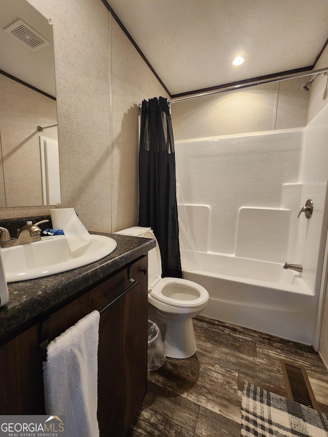 full bathroom featuring vanity, hardwood / wood-style flooring, toilet, and shower / bath combo with shower curtain