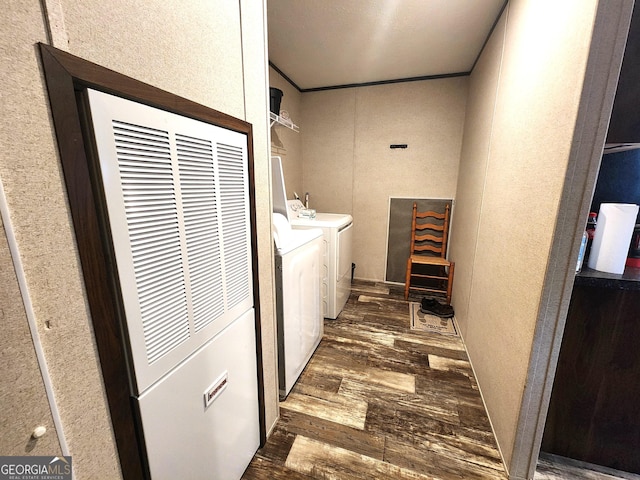 laundry area with crown molding, dark wood-type flooring, and independent washer and dryer