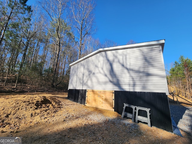 view of home's exterior with an outbuilding