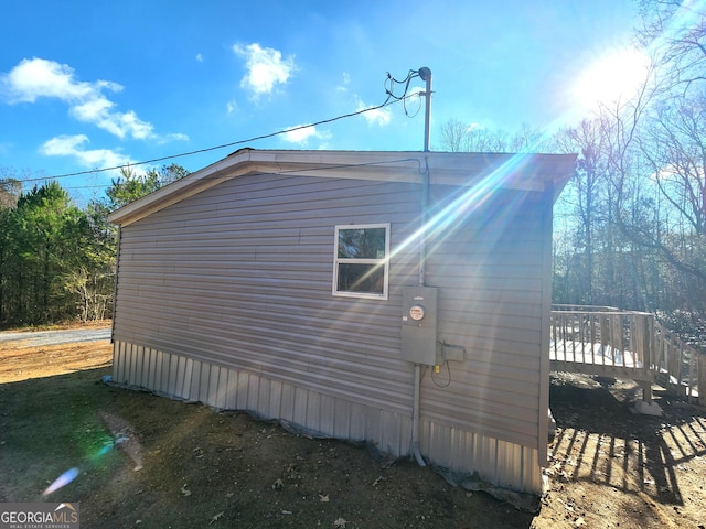 view of side of home with a deck