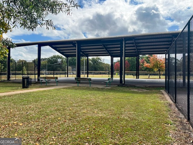 view of vehicle parking with a carport and a lawn