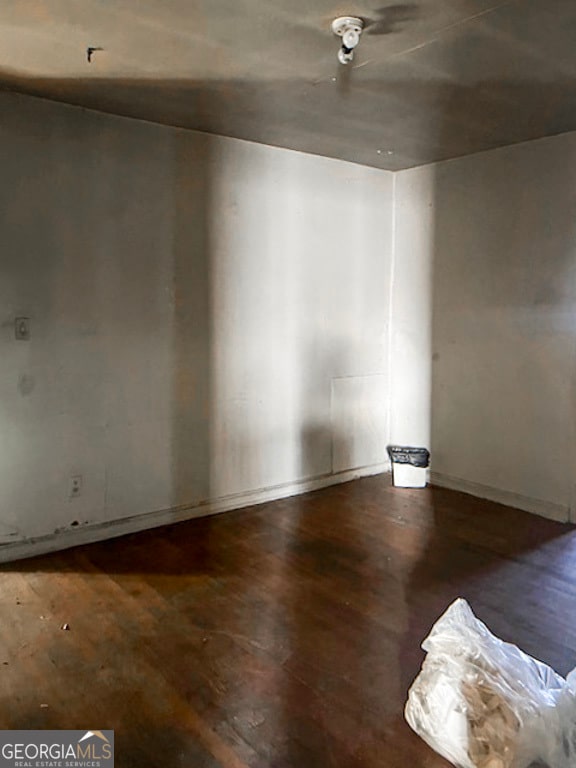 empty room featuring dark wood-type flooring