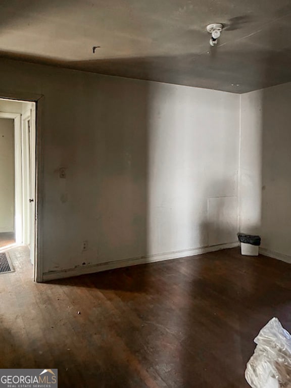 empty room with hardwood / wood-style floors