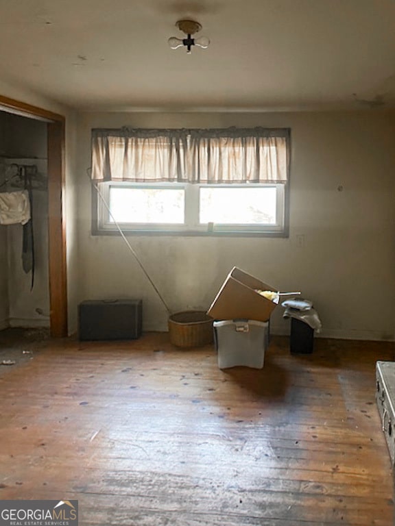 spare room featuring hardwood / wood-style floors and a healthy amount of sunlight