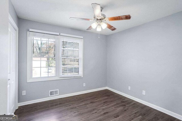 spare room with dark hardwood / wood-style flooring