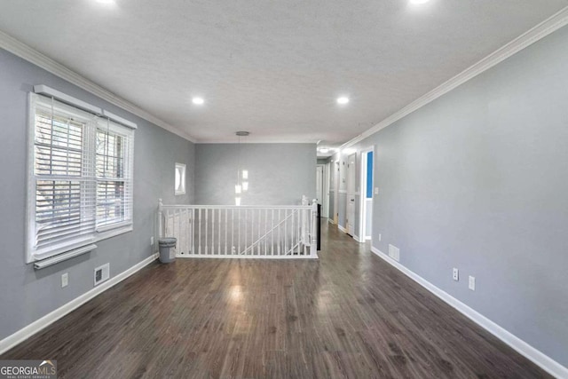 unfurnished room featuring dark hardwood / wood-style flooring and ornamental molding