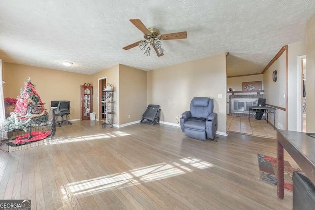 sitting room featuring hardwood / wood-style floors, a textured ceiling, and ceiling fan