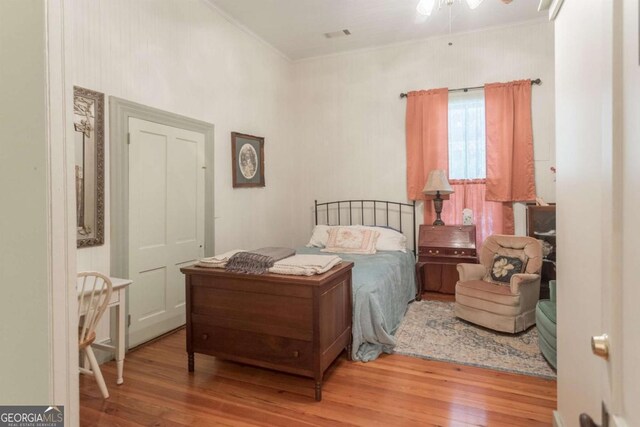 610 W Liberty, Claxton, GA 30417 - bedroom featuring light wood-type flooring and crown molding