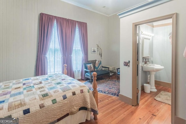 610 W Liberty, Claxton, GA 30417 - bedroom featuring hardwood / wood-style flooring, crown molding, and ensuite bathroom