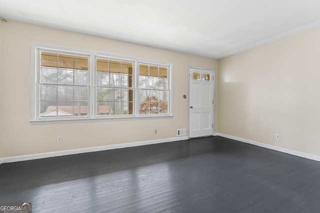 spare room with dark wood-type flooring