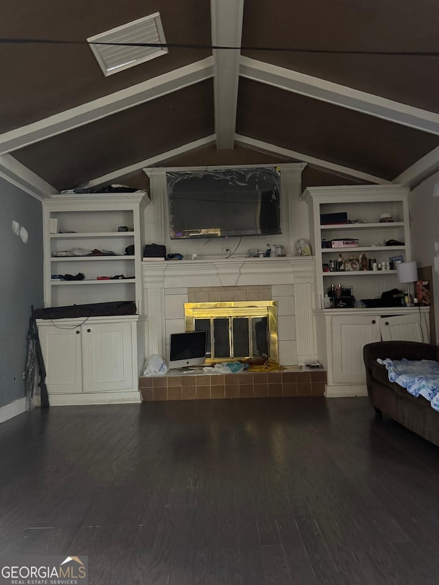 unfurnished living room featuring dark hardwood / wood-style flooring, vaulted ceiling with beams, and a fireplace