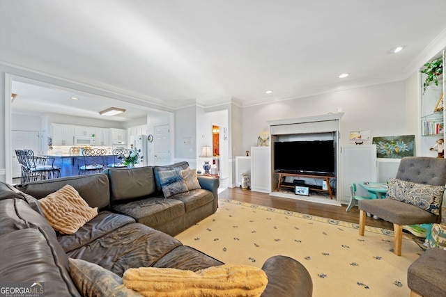 living room featuring light hardwood / wood-style flooring and crown molding