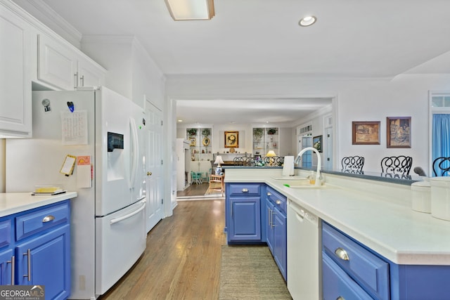 kitchen featuring white cabinets, white appliances, blue cabinets, and sink