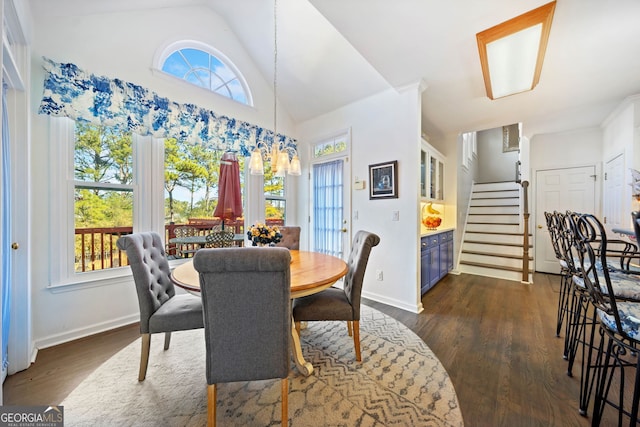 dining space with lofted ceiling and dark hardwood / wood-style floors