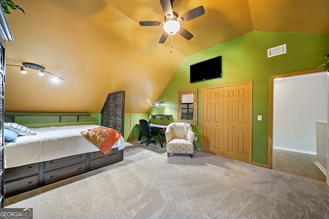 bedroom with ceiling fan, a closet, carpet, and lofted ceiling